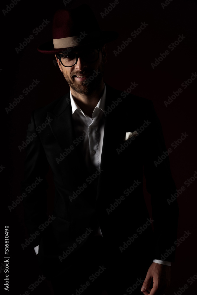 Positive fashion model smiling with his hand in his pocekt Positive fashion model smiling with his hand in his pocekt