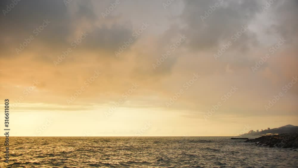 Golden sunset over the sea in cloudy rainy weather. Seascape. Time-lapse movie in 4k quality. Golden sunset over the sea in cloudy rainy weather. Seascape. Time-lapse movie in 4k quality.