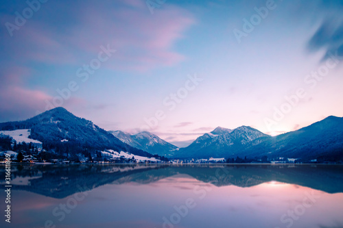 The beautiful lake Schliersee in the south of bavaria, germany, with mountains in the background, blue sky and nice reflections