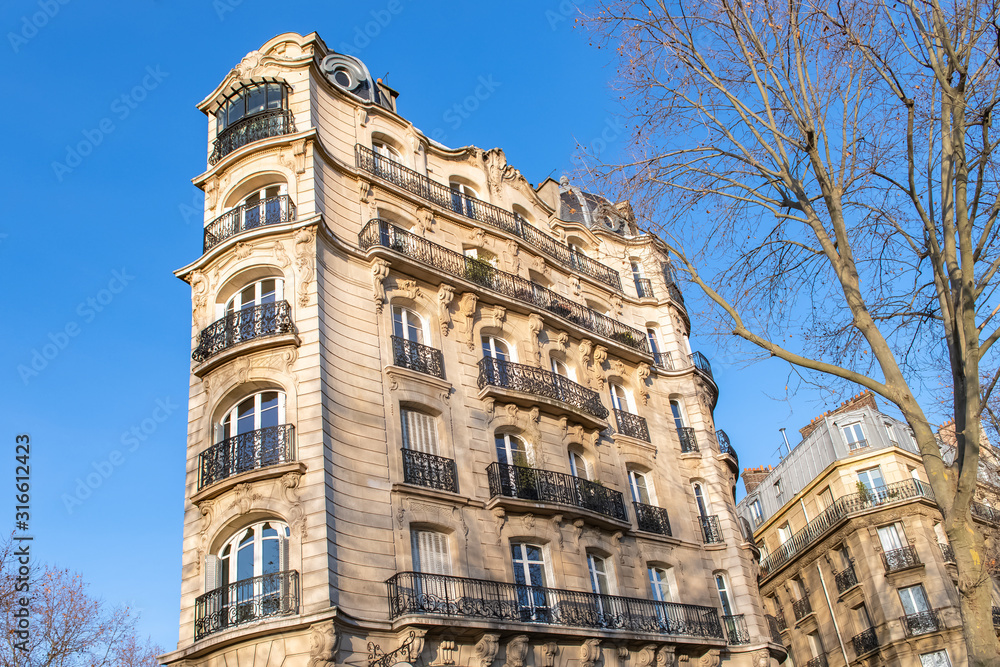 Paris, typical facade and windows, beautiful building boulevard du Montparnasse