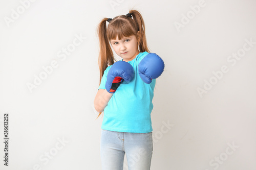 Little girl in boxing glove...