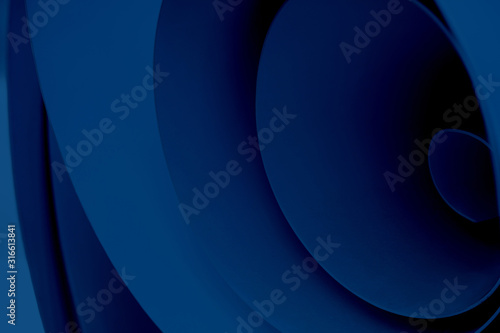 Blue abstract background of swirling material. Several planes twisted into a roll.