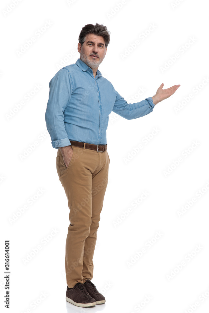 Smart casual man presenting with his hand in his pocket Smart casual man presenting with his hand in his pocket