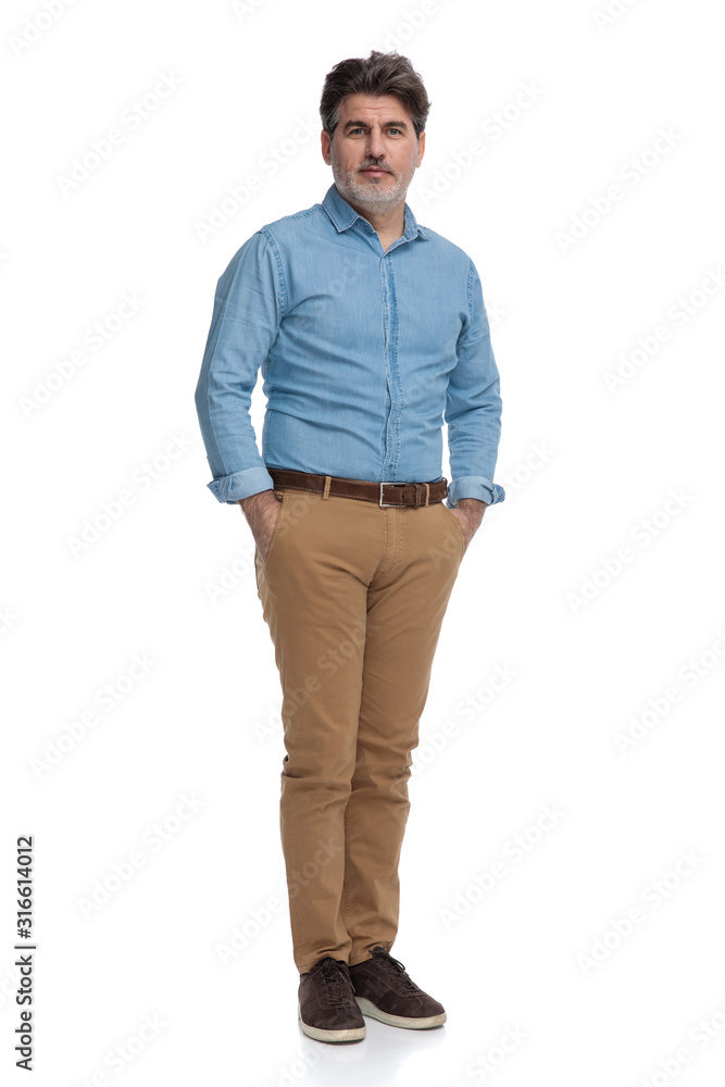 Confident casual man holding both hands in his pockets Confident casual man holding both hands in his pockets