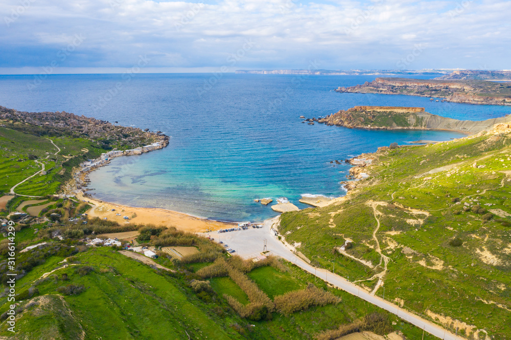 Aerial view of Gnejna bay beach. Winter, a lot of greeny, blue sea. Malta island