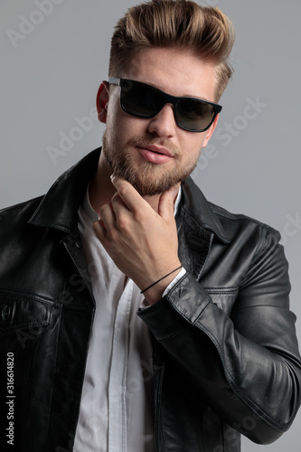 young fashion model in leather jacket touching beard © Viorel Sima
