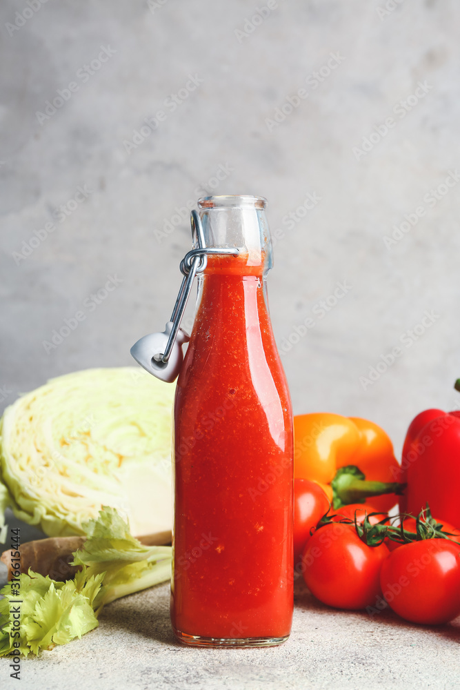 Bottle of fresh vegetable juice on table Bottle of fresh vegetable juice on table