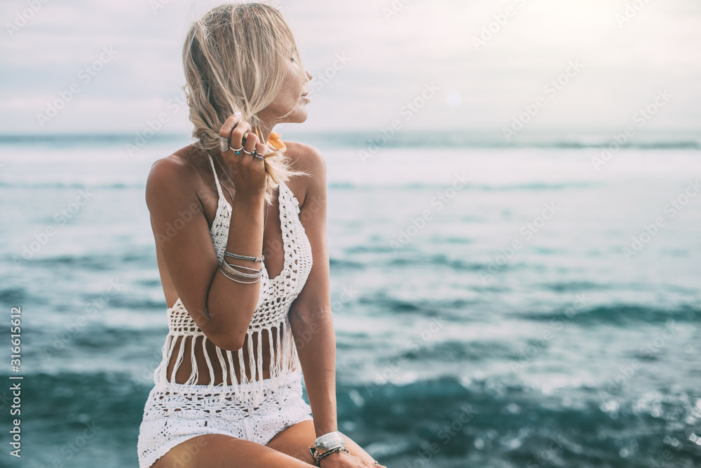 Boho model wearing crochet top and silver jewelry on the beach - obrazy, fototapety, plakaty 