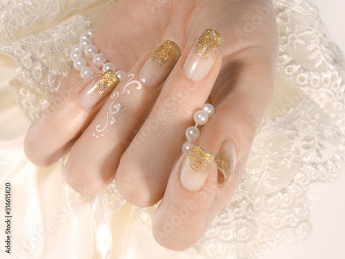 Woman's hand with golden manicure