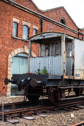 Close-up of outer wall of old abandoned train wagon science industry museum manchester space for text warm colors colour rust wheel rails vintage antique