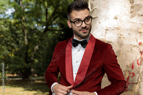 businessman standing against tree and opening his coat happy photo