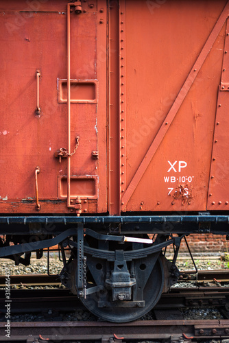 Close-up of outer wall of old abandoned train wagon science industry museum manchester space for text warm colors colour rust wheel rails vintage antique
