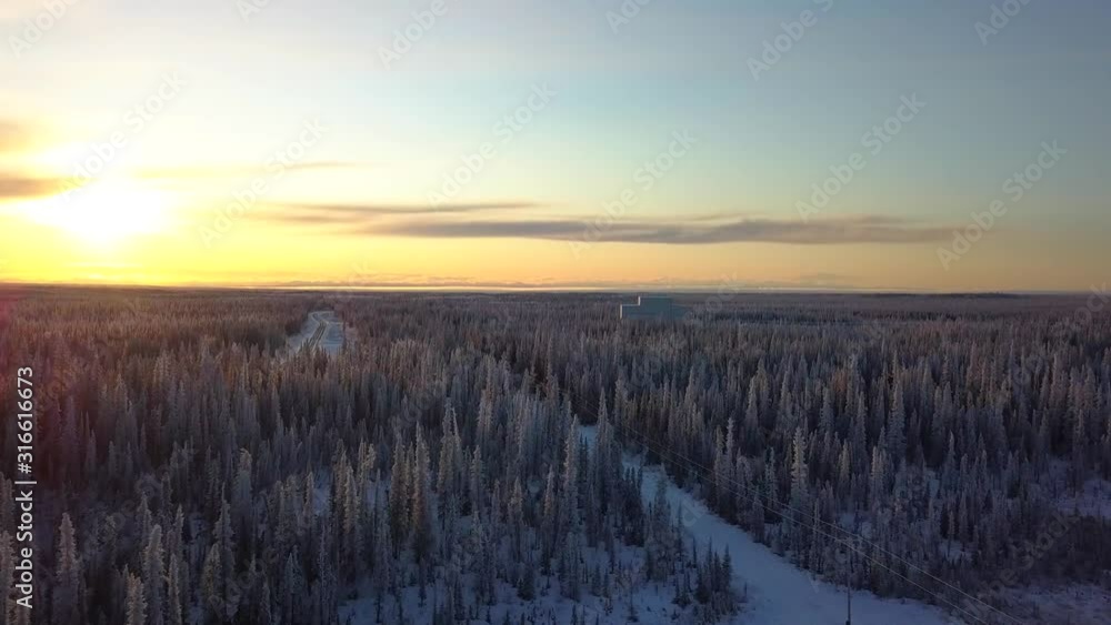 Aerial, drone shot, over snowy forest, towards the HAARP Alaska facility, at sunset, on a cold and sunny, winter day, in Gakona, USA Aerial, drone shot, over snowy forest, towards the HAARP Alaska facility, at sunset, on a cold and sunny, winter day, in Gakona, USA