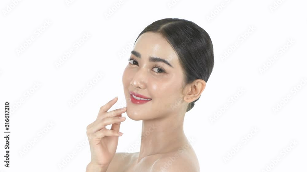 Beauty concept. A beautiful woman is gently caressing her face on a white background. 4k Resolution.