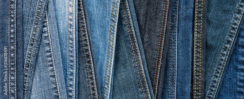 Obraz na płótnie Denim background. Blue jeans seams of different shades and textures. Banner w salonie