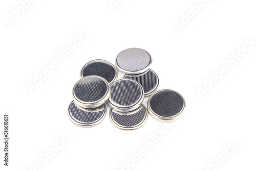Heap of lithium button cell batteries. Closeup. Isolated on white background.