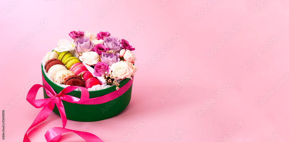 Festive concept from rosebuds in full bloom and Multicolored Macaroons on red background. Valentines Day. Template mock up of greeting card or text design Festive concept from rosebuds in full bloom and Multicolored Macaroons on red background. Valentines Day. Template mock up of greeting card or text design