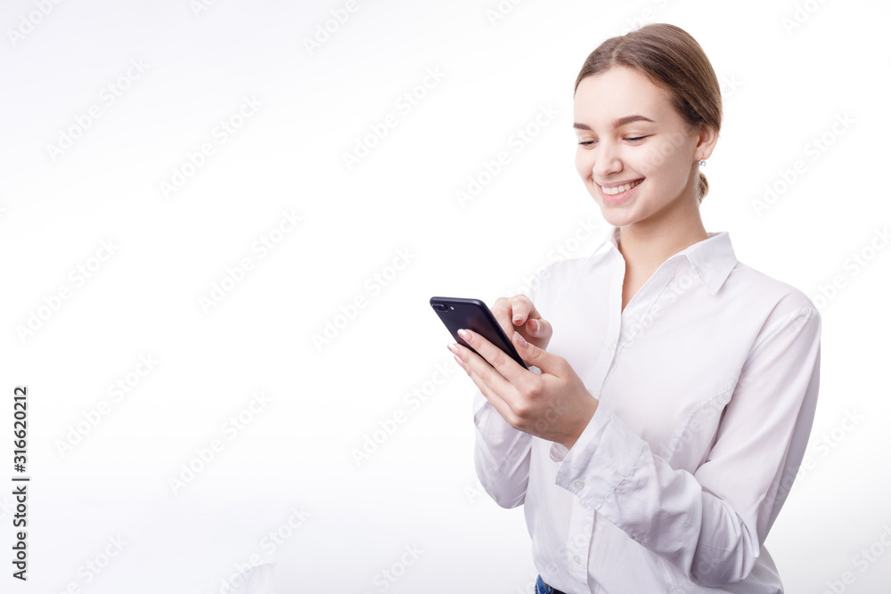 Smiling enthusiastic businesswoman in white blouse texting via smartphone isolated white background copyspace Smiling enthusiastic businesswoman in white blouse texting via smartphone isolated white background copyspace