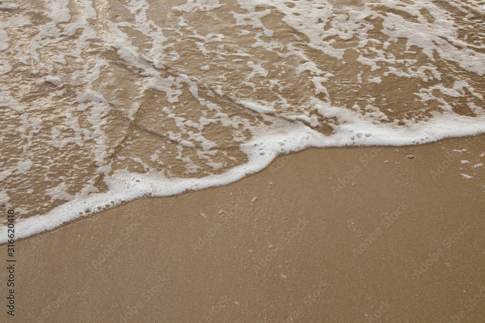 Sea water caressing the orange sand Sea water caressing the orange sand