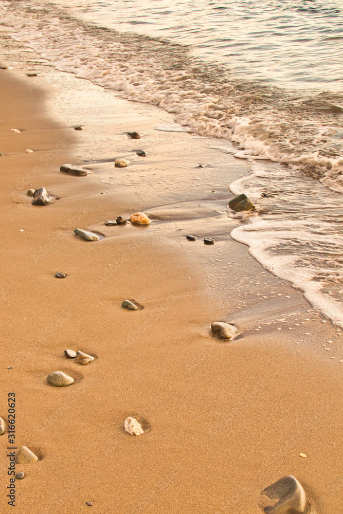 Sea water caressing the orange sand Sea water caressing the orange sand