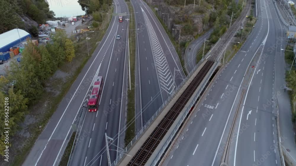 Aerial view of elevated highway interchange traffic. Drone shot flying over junction, cars and buses driving by. Urban transportation background in 4K resolution. Stockholm, Sweden Aerial view of elevated highway interchange traffic. Drone shot flying over junction, cars and buses driving by. Urban transportation background in 4K resolution. Stockholm, Sweden