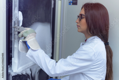 Wallpaper Mural Young Female Research Scientist working with a Cold Nitrogen Liquids in a Laboratory. Genetics and Pharmaceutical Studies and Researches. Torontodigital.ca