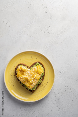 heart shaped healthy avocado toast with scrambled egg