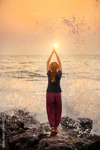 Beautiful yoga meditation reflection on water Goa beach on sunset © gilitukha