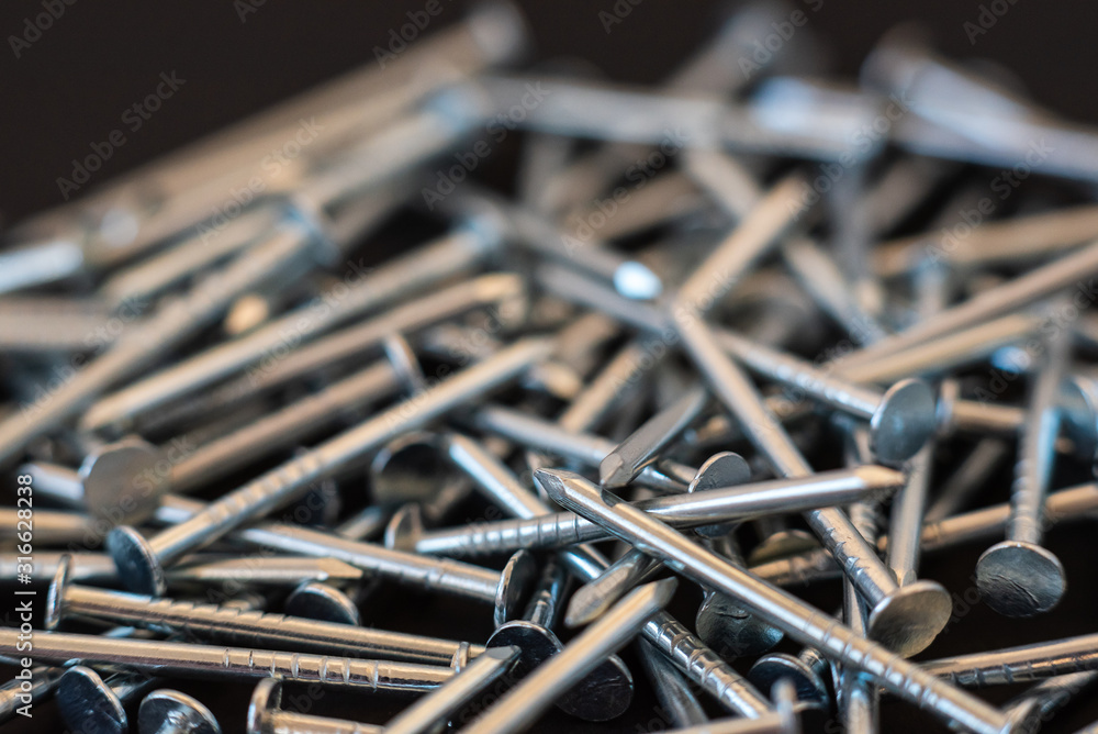 Fototapeta premium metal construction nails close-up on black background