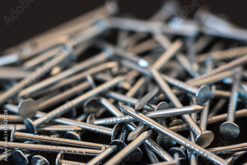 metal construction nails close-up on black background