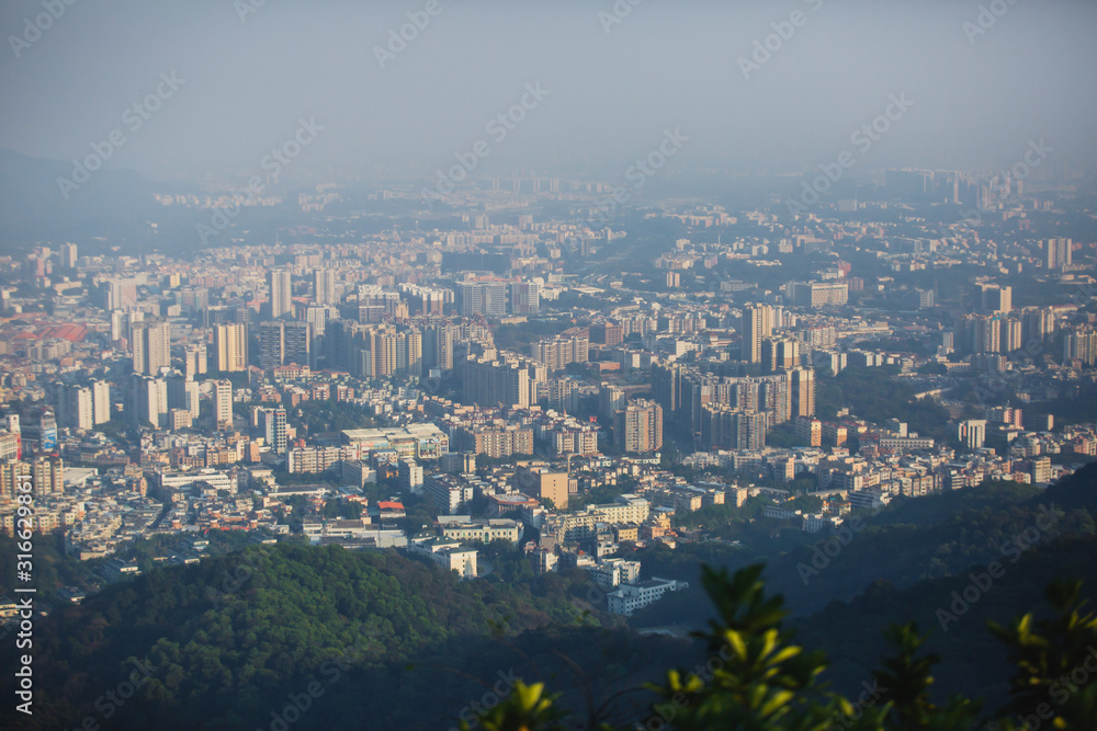 Fototapeta premium View of Guangzhou city with Zhujiang New Town from White Cloud Mountain, Baiyun Mountain, Guandong, China, sunny summer day