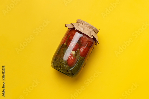 a simple minimalist concept, with jar of pickled vegetables on the color background with copy space