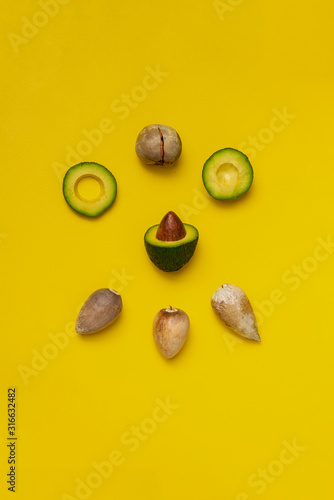 the sliced avocado with a big seed, organic raw product, growing avocado plant