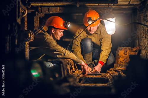 Two miners in the mine photo