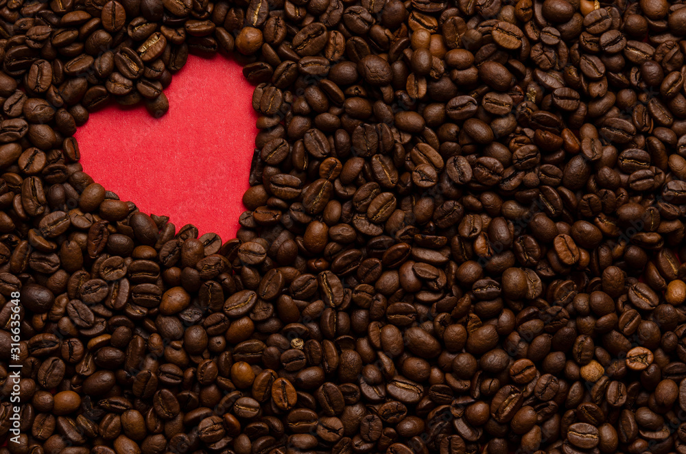 Red heart from coffee beans on coffee background Red heart from coffee beans on coffee background