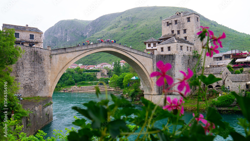 Mostar, Bosnia and Herzegovina, April 2019: Old bridge in Mostar on a rainy day.