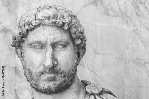 Black and white close up photo of male head of classical roman statues