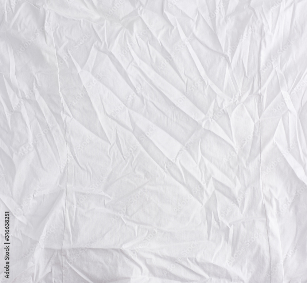 Naklejka premium crumpled white cotton fabric, fabric for sewing clothes and shirts