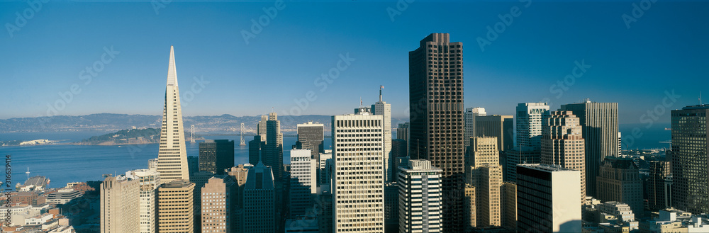 This is the Transamerica Building and skyline in daylight. The Bay Bridge is very small in the background. It is the view from the Fairmont Hotel. This is the Transamerica Building and skyline in daylight. The Bay Bridge is very small in the background. It is the view from the Fairmont Hotel.