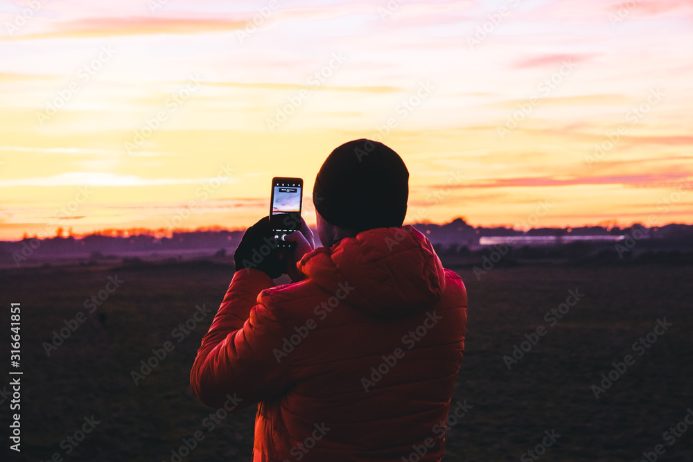 Photographer Taking A Photo Of A Sunset. Photographer Taking A Photo Of A Sunset.