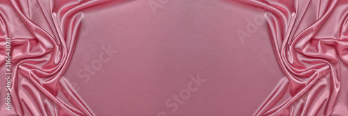 Abstract background from pink silk or satin. Luxury fabric texture with draped. Copy space. Element design. Valentine's day. photo
