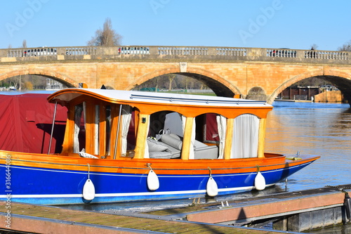Narrow old fashioned boat. Henley Royal Regatta 2020 takes place from Wednesday 1st to Sunday 5th July for five days. Popular Oxfordshire event attracts thousands of visitors annually to river Thames © Rusana