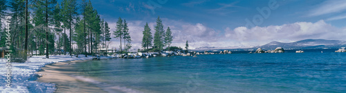 This is the sandy beach at Lake Tahoe. It shows the turquoise water in the winter after a snow storm. © spiritofamerica