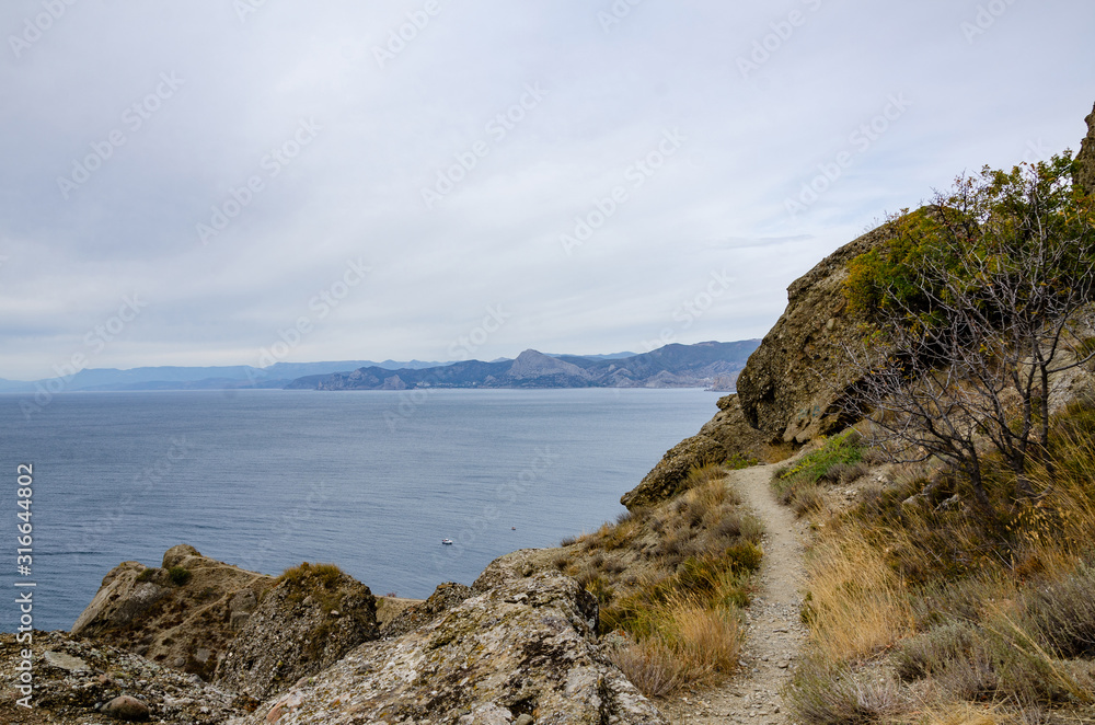 Mountain landscape. Mountain trail off the coast. Travel and adventure.
