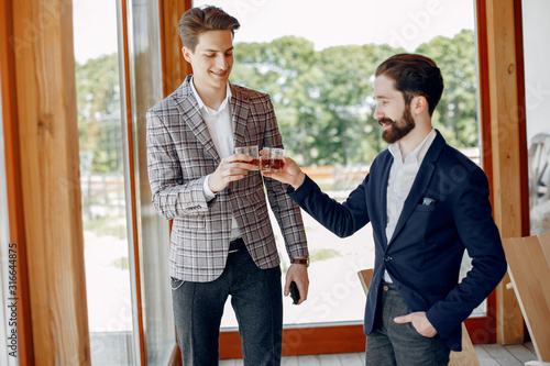 Two handsome men working. Friends talking. Man in a suit photo