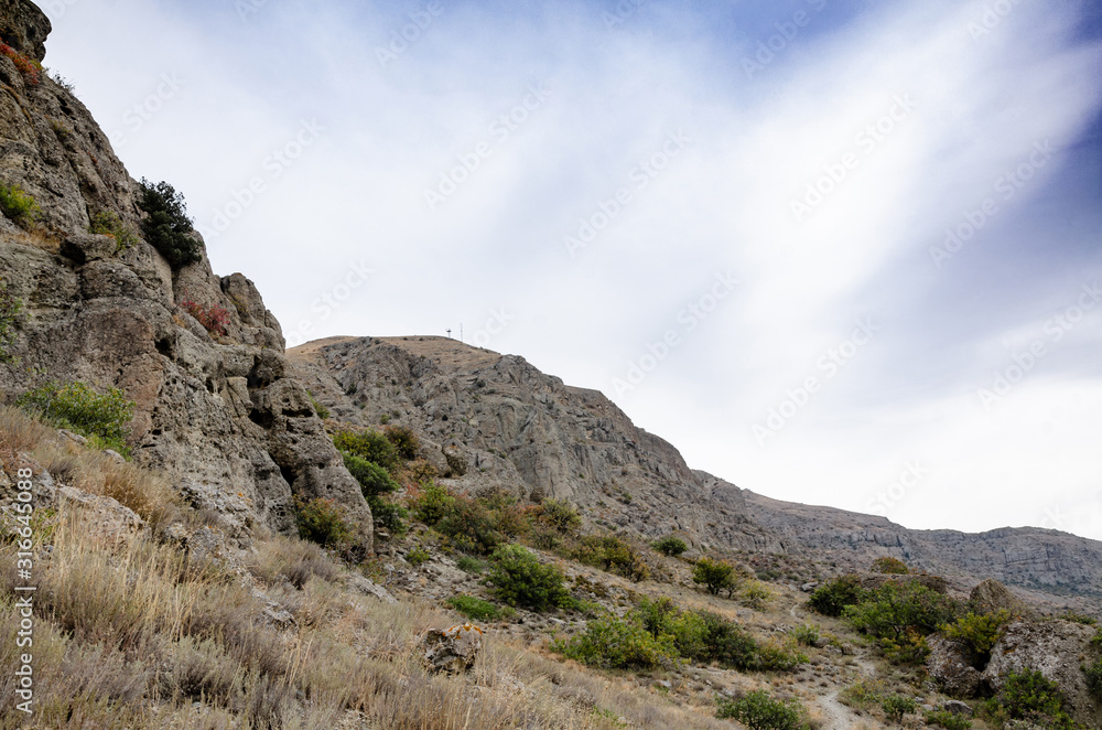 Mountain landscape. Blue sky and rock. View from the bottom.