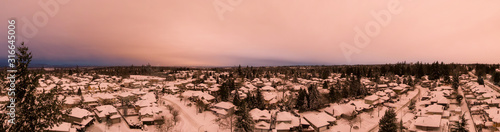 Aerial Panoramic View of a Residential Neighborhood with homes in white after a big snow storm in the Lower Mainland during sunset. Taken Greater Vancouver  BC  Canada.