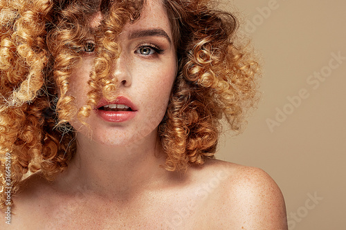 Redhair natural woman with freckles.