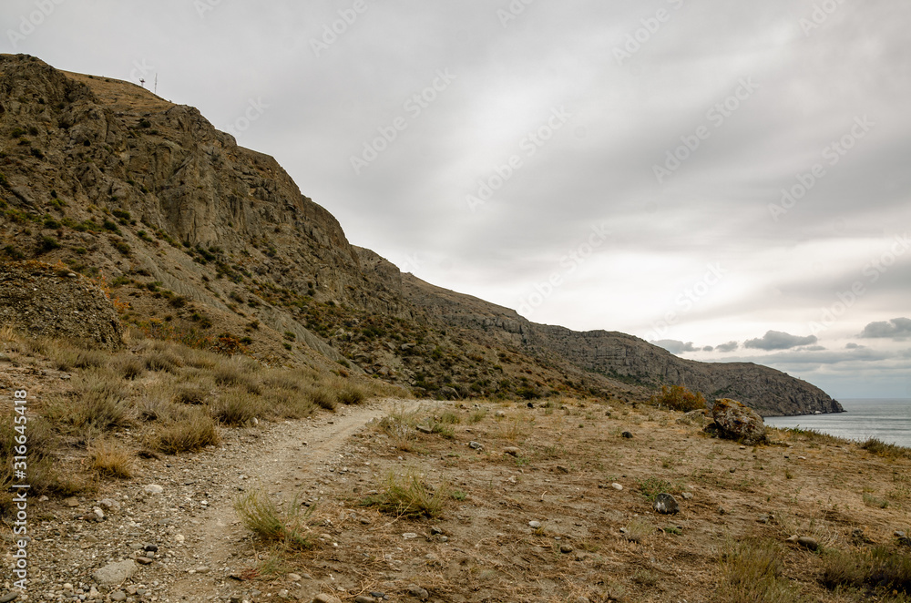 Mountain landscape. Mountain trail off the coast. Travel and adventure.