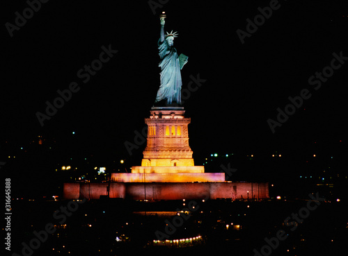 This is the Statue of Liberty lit up at night on Liberty Weekend. It was taken from the Aircraft Carrier Kennedy.